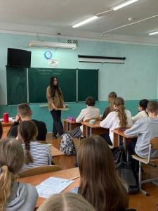 A teacher in front of a class of students; Bluerain School Management Software