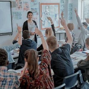 A teacher standing in front of a class lecturing students.; Bluerain School Management Software