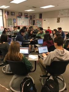 College students sitting using computers for classroom activities ; Bluerain School Management Software